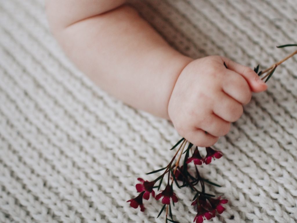 Baby hands and flowers